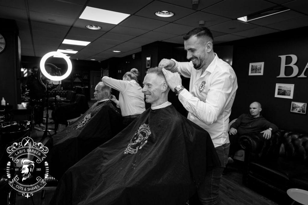 Barber working inside Labi's Barber